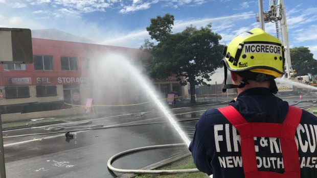 Ongoing battle: Firefighters battle the blaze at Rent A Space in Brookvale. 