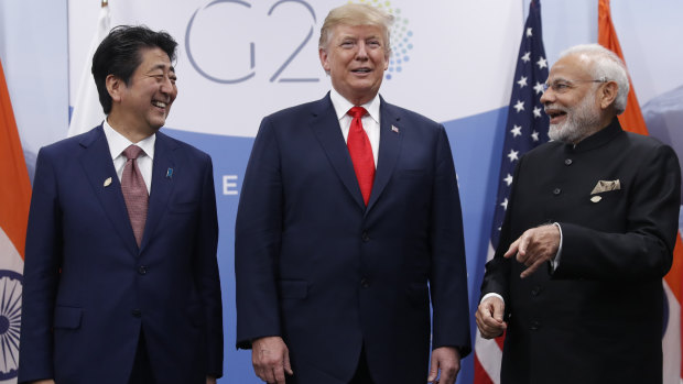 US President Donald Trump  with India's Prime Minister Narendra Modi, right, and Japan's Prime Minister Shinzo Abe, on Friday.