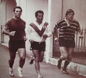 John Sattler in his volleys, along with Souths teammates Eric Simms and Bob McCarthy, jog the back streets of Redfern.
