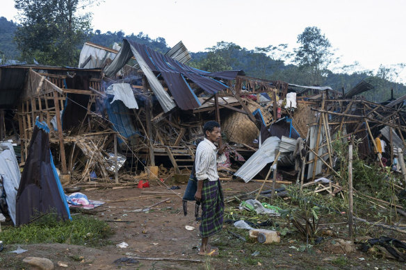 A man looks on at homes destroyed after air and artillery strikes in Mung Lai Hkyet displacement camp, in Laiza, Myanmar, on Tuesday.