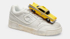All-leather Soho sneaker by Coach, with a taxi charm.