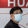Visitors walk past a Huawei store at the Wushang Dream Plaza mall, the world’s largest single shopping mall, in Wuhan.