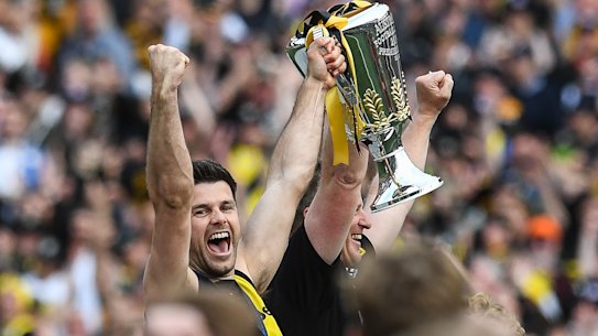 Trent Cotchin and Damien Hardwick lift the premiership cup.