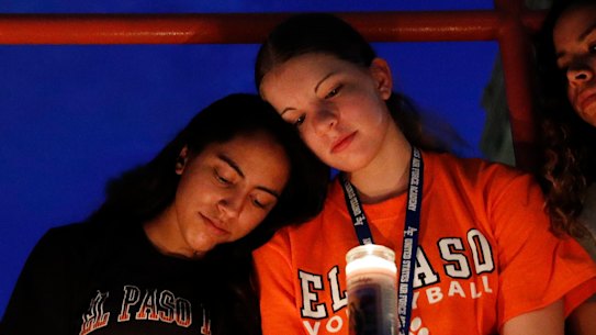 From left, Melody Stout, Hannah Payan, Aaliyah Alba, Sherie Gramlich and Laura Barrios comfort each other during a vigil for victims of the shooting on Saturday.