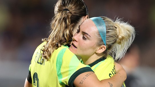 Wini Heatley gets a hug from Ellie Carpenter at full-time in Gosford.