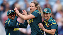 Ellyse Perry of Australia celebrates with teammates Sophie Molineux and Alana King after taking the wicket of Shorna Akter of Bangladesh.