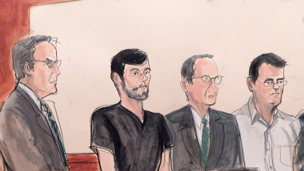 Evan Greebel (on right, in white shirt) with Martin Shkreli (second from left) and their defense attorneys in court as they faced their conspiracy charges.
