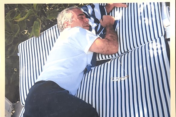 Jeffrey Epstein takes a nap on a lounge bed.