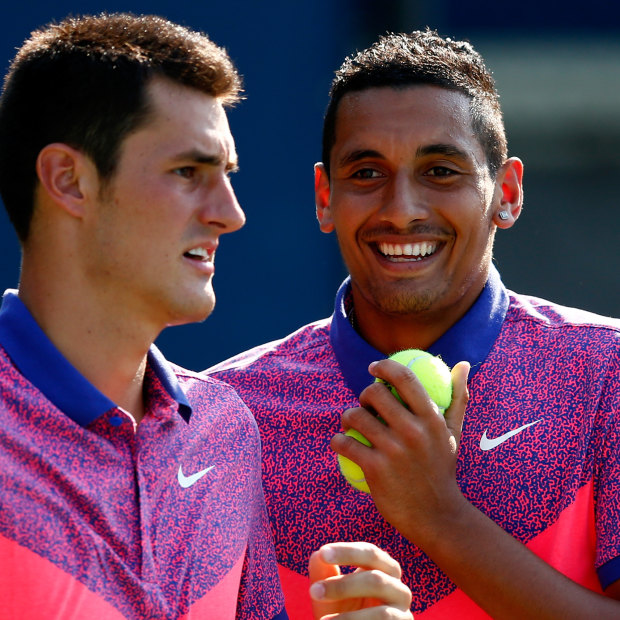 Bernard Tomic and Nick Kyrgios playing doubles at the 2014 US Open during a happier time.