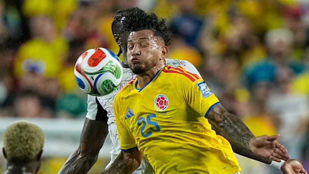 Colombia's Luis Suarez (25) and Ghana's Jerome Opoku battle.