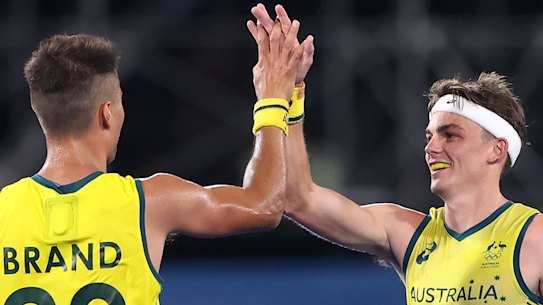 Tim Brand celebrates with teammate Tim Howard after scoring the Kookaburras’ seventh goal during the Men’s Preliminary Pool A match between India and Australia on day two of the Tokyo Olympics.