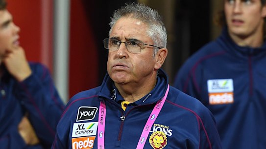 Lions coach Chris Fagan walks onto the field during the round 2 clash with Geelong on Friday night. 
