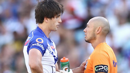 Lachlan Lewis is assessed on the field for concussion by the Bulldogs trainer.