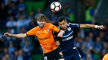 Brett Holman (left) fights for the ball during the A-League Semi Final against Melbourne Victory on April 30, 2017.