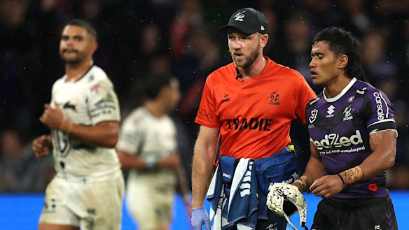Sualauvi Fa’alogo is taken from the field for a head injury assessment after a high tackle from Latrell Mitchell.