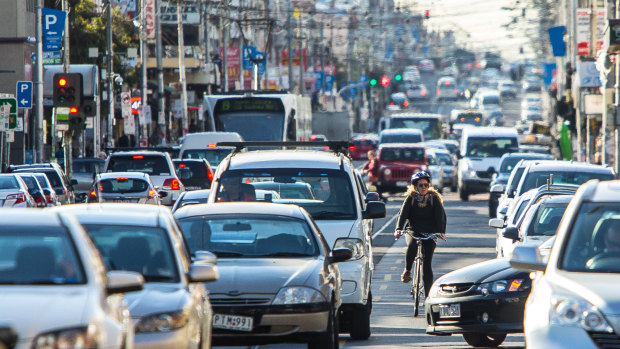 A cyclist making their way along Sydney Road, one of the most dangerous routes in the city.