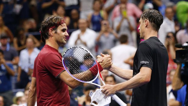 John Millman and Roger Federer shake hands after the Australian won their match at the US Open in 2018.
