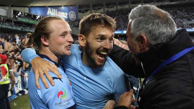 Best day of his life: Milos Ninkovic, centre, celebrates after his penalty earned Sydney FC the 2016-17 A-League title.