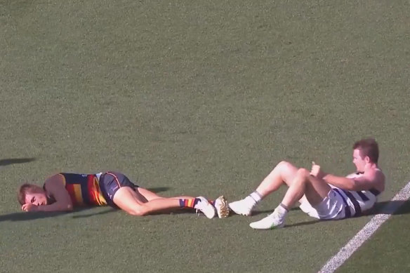 Crows defender Jake Kelly, left, out cold. 