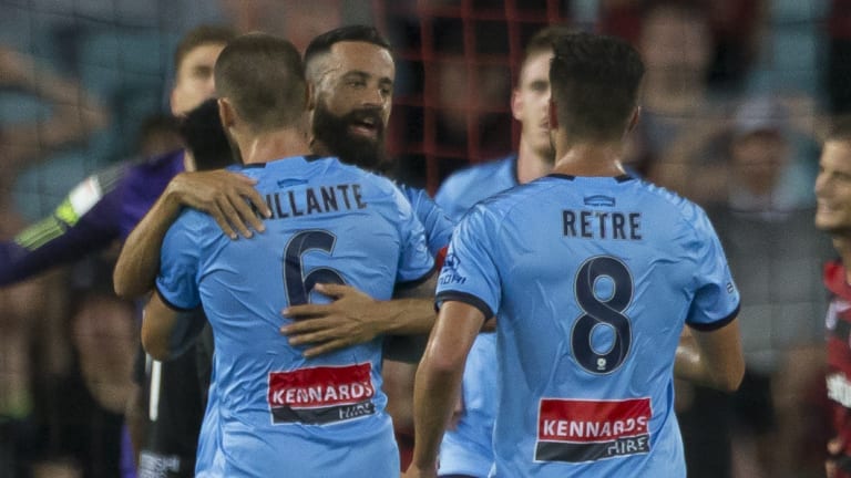 Fated: Alex Brosque is mobbed as Sydney FC launch their comeback.