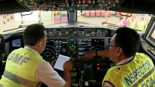 Officials inspect the cockpit of a Boeing 737 MAX 8 aircraft in a hangar Jakarta earlier this month.
