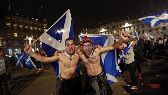 Supporters from the "Yes" Campaign wave Scottish  flags in central Glasgow on the night of the September referendum.