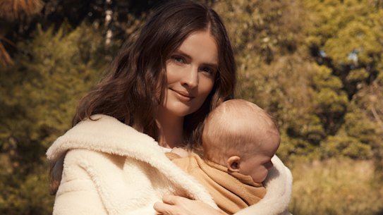 Laura Henshaw, with baby Atlas. Laura wears Max Mara coat. Zara dress and boots. Atlas wears Nature Baby (throughout).