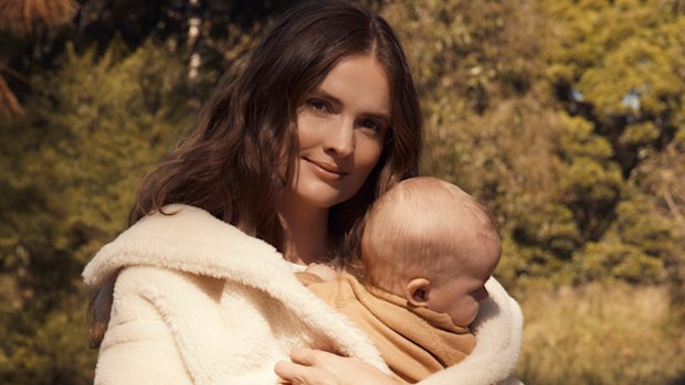 Laura Henshaw, with baby Atlas. Laura wears Max Mara coat. Zara dress and boots. Atlas wears Nature Baby (throughout).