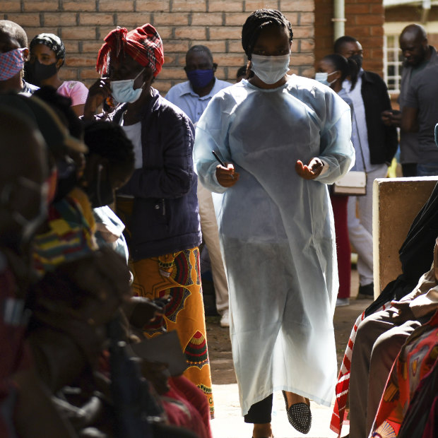 Numbers are handed out to people waiting to receive the AstraZeneca COVID-19 vaccine at Ndirande Health Centre in Blantyre Malawi.