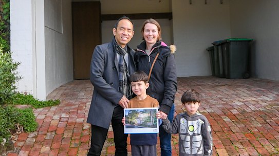 Craig Tan with wife Gemma and their children after their success at the auction.