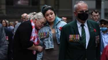 Megan Rull, 29, whose partner, an Afghanistan veteran, took his own life last year, is comforted by Joanne Beavis, from Legacy, at the Centotaph in Martin Place.