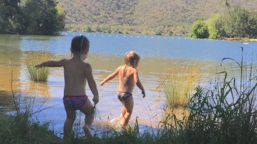 Heidi Young (5) and Emma Young (3) frolic in the shallows of Lake Burley Griffin at Black Mountain Peninsula.