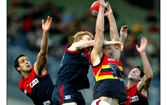 Troy Broadbridge (centre) in action for the Demons.