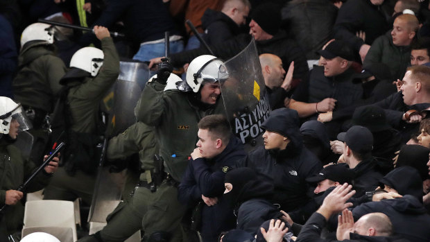 Greek riot police clash with Ajax fans in Athens.