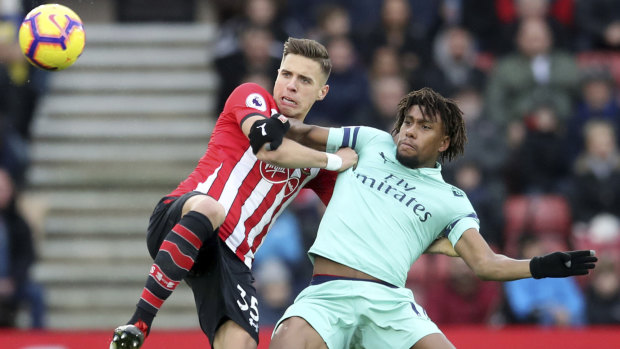 Southampton's Jan Bednarek and Arsenal's Alex Iwobi challenge for the ball at St Mary's in Southampton on Sunday.