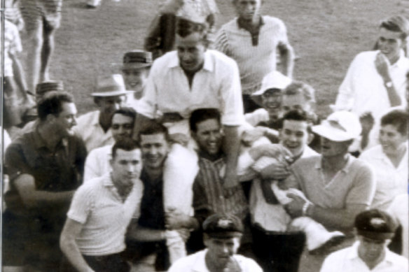 Ian Meckiff is chaired off the field by spectators after the innings.