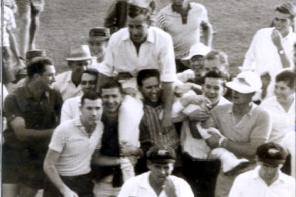 Ian Meckiff is chaired off the field by spectators after the innings.