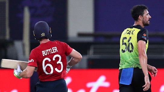 Australia’s Mitchell Starc, center reacts as England’s Jos Buttler, left, and Jason Roy run between wickets during the Cricket Twenty20 World Cup match between Australia and England in Dubai, UAE, Saturday, Oct. 30, 2021. (AP Photo/Aijaz Rahi
