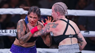Alma Garcia, left, takes a hit from Bec Rawlings during a 125-pound bout at the Bare Knuckle Fighting Championship in 2018. Rawlings will fight in Perth at the BKFC event on July 19.