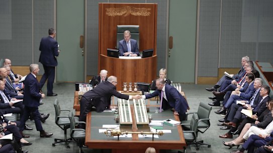 Democracy at work: Prime Minister Scott Morrison reaches across the table to shake hands with Opposition Leader Anthony Albanese.