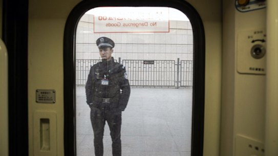 A police officer is seen through a train window as he stands on a platform at a railway station in Turpan, Xinjiang autonomousÂ region, China, on Tuesday, Nov. 6, 2018. Although it represents just 1.5 percent of China's population and 1.3 percent of its economy, Xinjiang sits at the geographic heart of Xi's signature Belt and Road Initiative. Source: Bloomberg