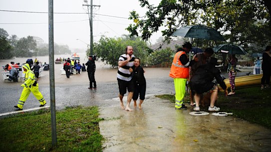 People make their way to safety in Lismore on February 28.