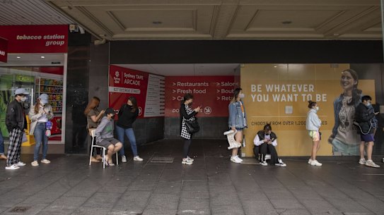 People lining up for a COVID-19 PCR test in Sydney CBD brought their own chairs on Tuesday.