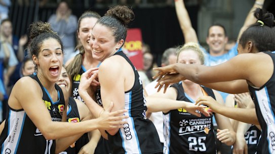 Canberra Capitals teammates cheer their co-captain Kelsey Griffin. Photo: Sitthixay Ditthavong