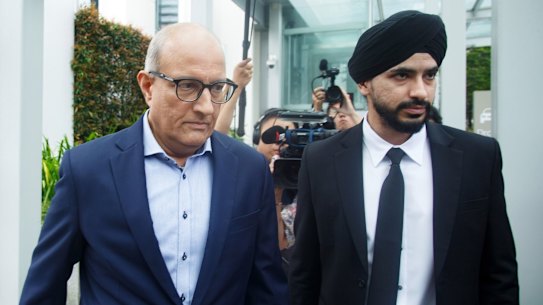 S. Iswaran, Singapore’s transport minister, left, leaves the State Courts in Singapore, on Thursday. Iswaran was charged with corruption, the latest development in the biggest political scandal to hit the city state in close to four decades.