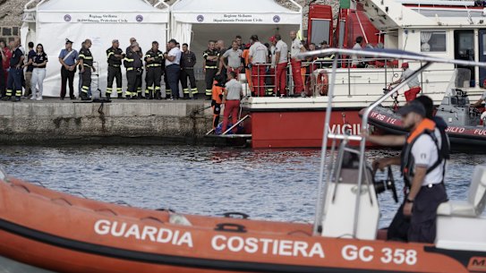 Rescue divers deliver a fifth body bag to the shore after recovery from the luxury yacht Bayesian, which sank off the coast of Porticello, Sicily.