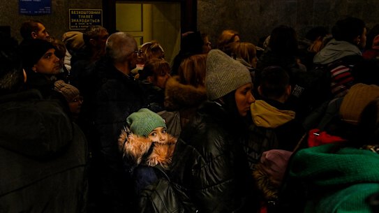 Crowds inside Lviv railway station queue to catch the train to Poland.