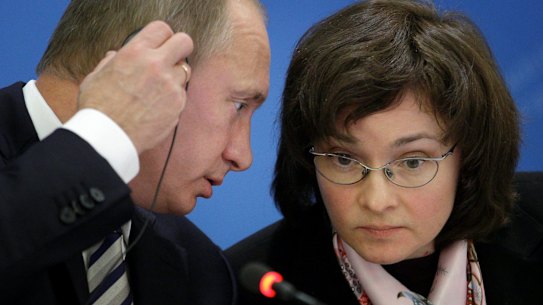 Russian Prime Minister Vladimir Putin and Elvira Nabiulina speaking in 2008.