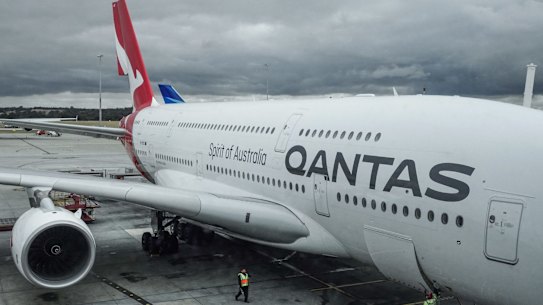 MELBOURNE, AUSTRALIA - DECEMBER 12: A QANTAS jet prepares for boarding on the tarmac at Melbourne Airport on December 12, 2019. Photo by Paul Rovere Qantas Airways Limited is theÂ flag carrierÂ of Australia and its largest airline by fleet size, international flights and international destinations.