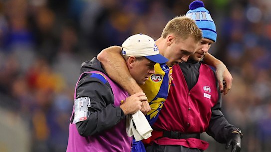 Oscar Allen is assisted from the field with a lower left leg injury on Sunday.